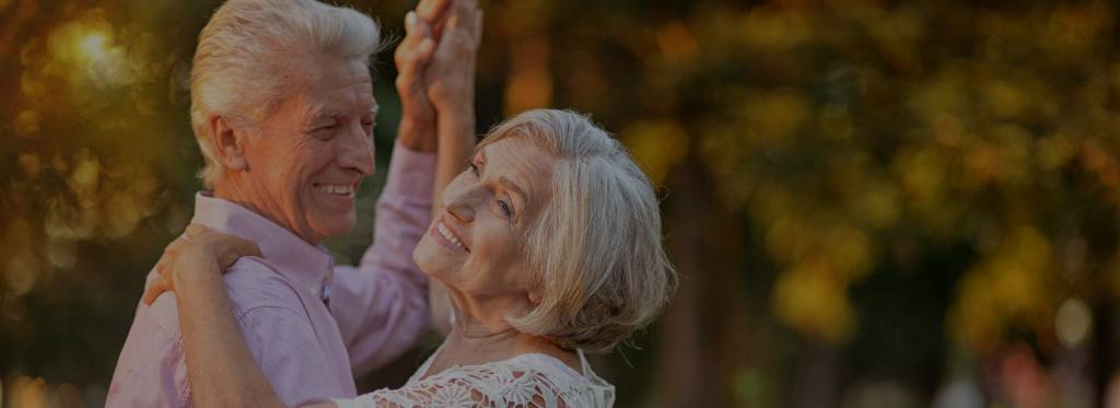 senior couple dancing outside